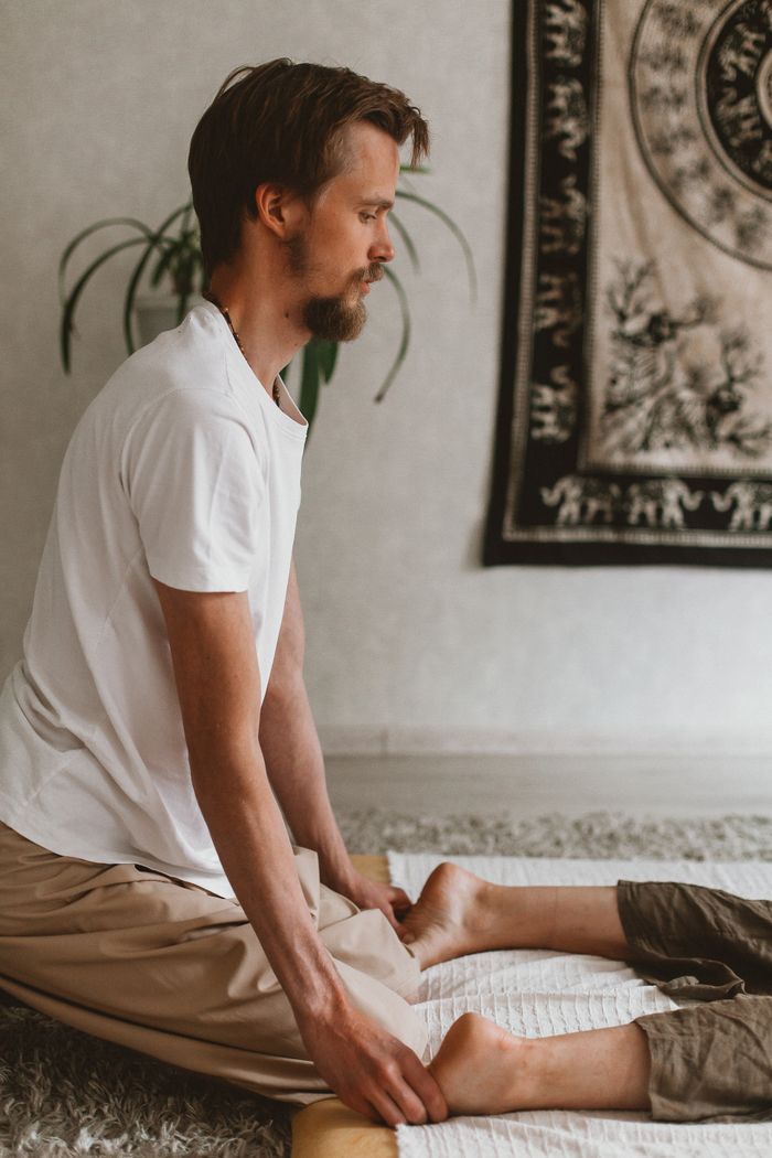 A massage therapist performing a session in a serene indoor setting with warm tones.