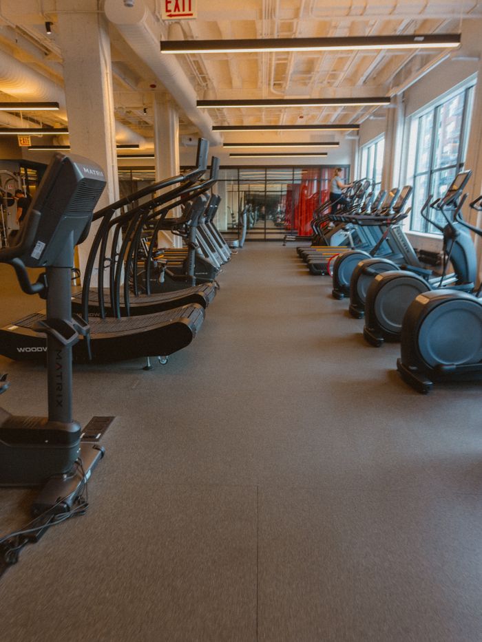 Spacious fitness center featuring treadmills, ellipticals, and exercise bikes for a complete workout.
