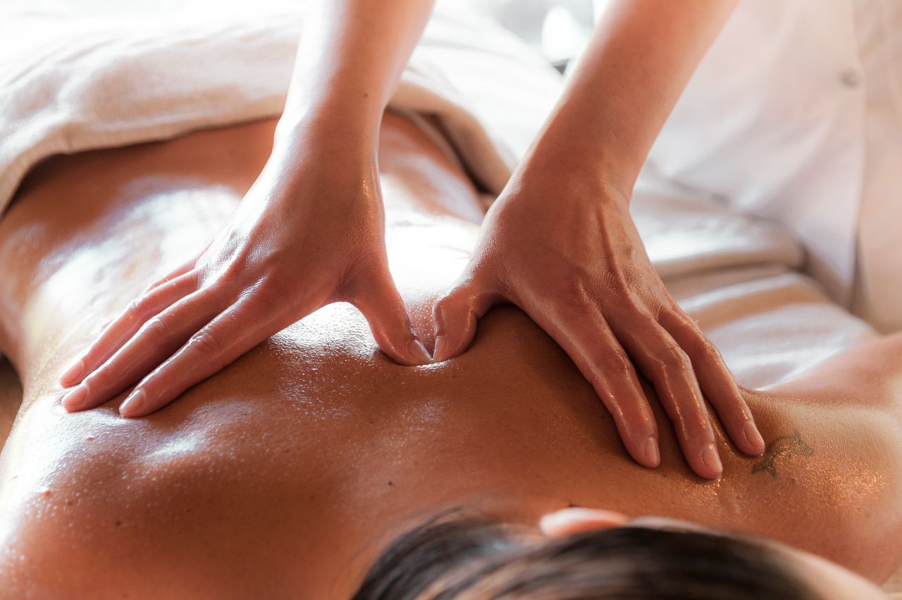 Close-up of a relaxing massage session, focusing on back therapy at a spa.